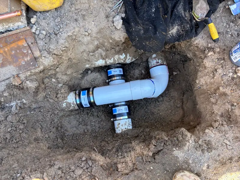 New PVC junction joined with flexible rubber couplings in an excavated hole