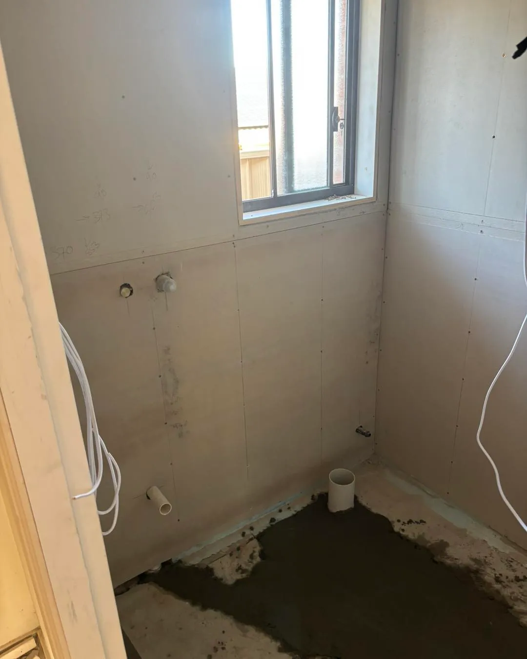 Bathroom stripped back for renovation with new pipework roughed in
